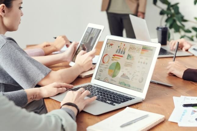 person at laptop working on creating graphs